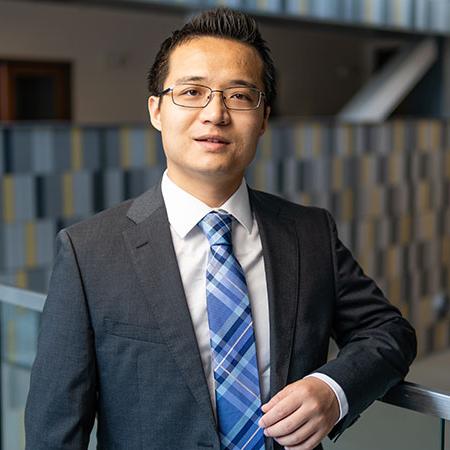 man with glasses and a suit and tie